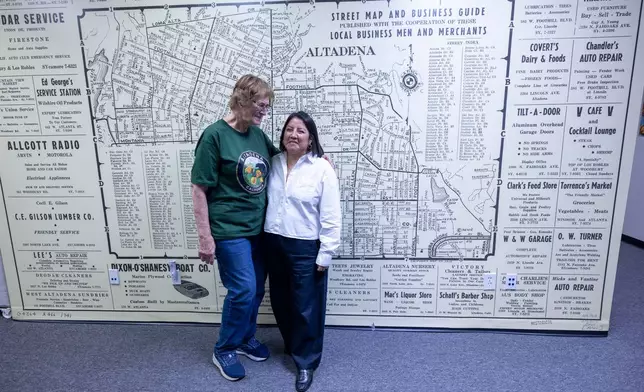 Veda Ashby Romero, right, a disaster case manager for CORE, poses for a portrait with Mary Landau, a fire survivor, at the CORE resource center on Thursday, Oct. 15, 2026, in Altadena, Calif. (AP Photo/Jill Connelly)