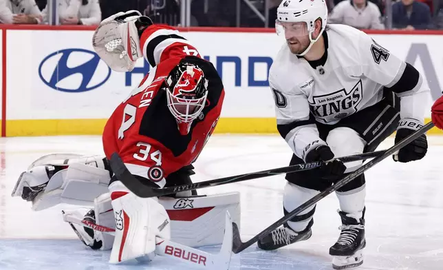 Los Angeles Kings right wing Joel Armia (40) has his shot defended by New Jersey Devils goaltender Jake Allen during the third period of an NHL hockey game Saturday, Oct. 24, 2026, in Newark, N.J. (AP Photo/Adam Hunger)