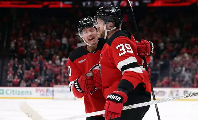 New Jersey Devils right wing Anthony Mantha (39) is congratulated by Jesper Boqvist (70) after scoring a goal during the second period of an NHL hockey game against the Los Angeles Kings, Saturday, Oct. 24, 2026, in Newark, N.J. (AP Photo/Adam Hunger)