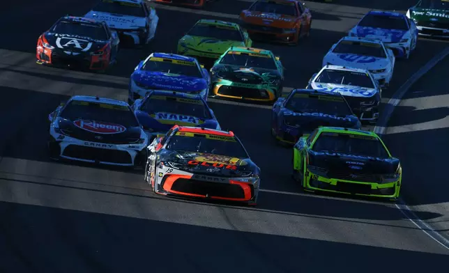 Chase Briscoe (19) leads the field through Turn 1 during a NASCAR Cup Series auto race Sunday, Oct. 4, 2026, in Las Vegas. (AP Photo/Sam Morris)