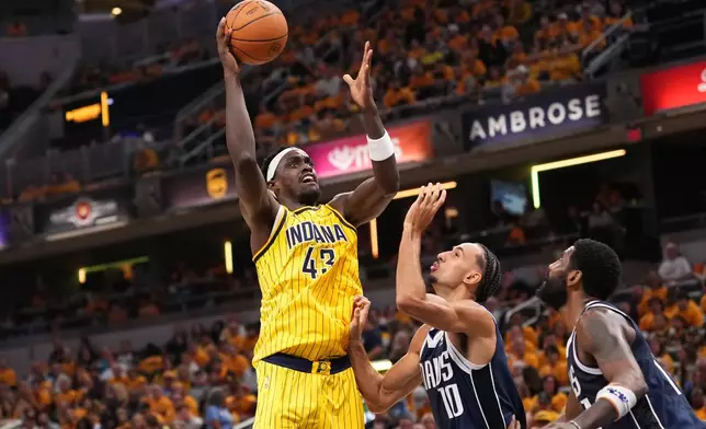 Indiana Pacers forward Pascal Siakam (43) looks to shoot over Dallas Mavericks forward Zaccharie Risacher (10) during the first half of an NBA basketball game in Indianapolis, Friday, Oct. 23, 2026. (AP Photo/AJ Mast)