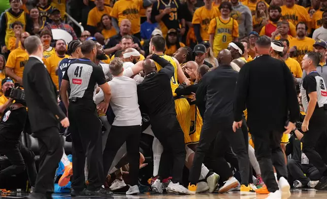 Players from the Dallas Mavericks and the Indiana Pacers scuffle after a hard foul during the first half of an NBA basketball game in Indianapolis, Friday, Oct. 23, 2026. (AP Photo/AJ Mast)
