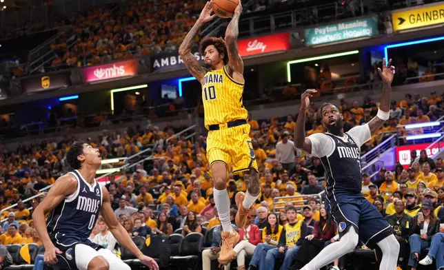 Indiana Pacers forward-guard Kelly Oubre Jr. (10) goes up to pass the ball over Dallas Mavericks guard Max Christie (0) during the first half of an NBA basketball game in Indianapolis, Friday, Oct. 23, 2026. (AP Photo/AJ Mast)