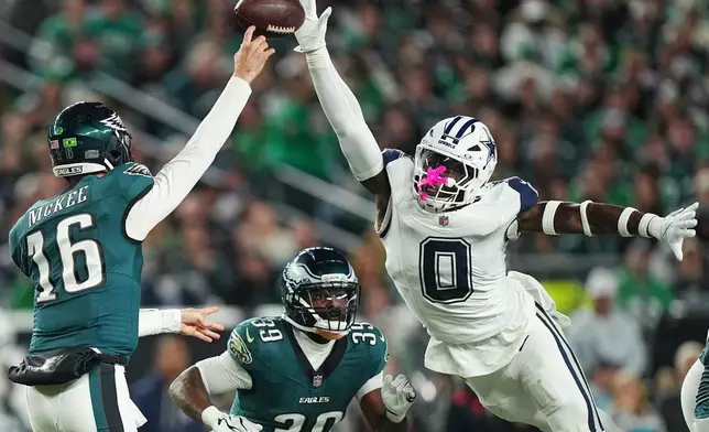 Dallas Cowboys' DeMarvion Overshown blocks a pass by Philadelphia Eagles quarterback Tanner McKee (16) during the first half of an NFL football game in Philadelphia, Monday, Oct. 26, 2026. (AP Photo/Matt Rourke)
