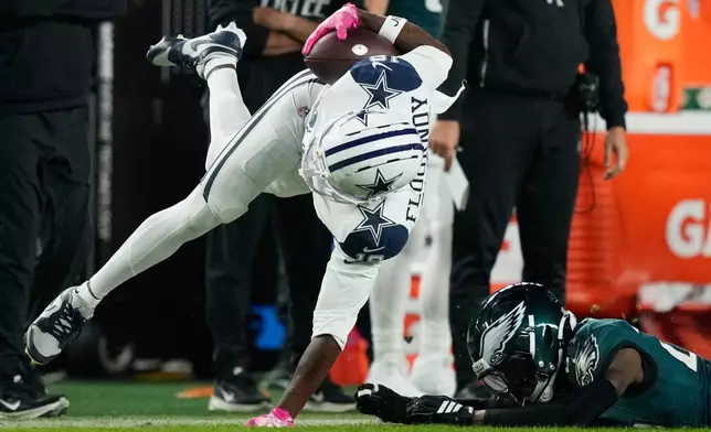 Dallas Cowboys wide receiver Ryan Flournoy (19) is tackled by Philadelphia Eagles safety Andrew Mukuba (24) after a catch during the first half of an NFL football game in Philadelphia, Monday, Oct. 26, 2026. (AP Photo/Matt Slocum)