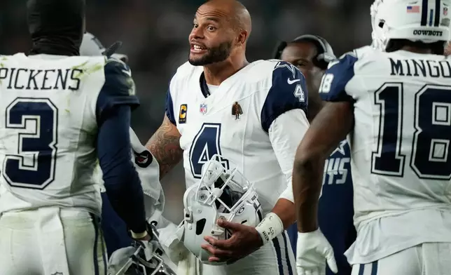 Dallas Cowboys quarterback Dak Prescott (4) talks with teammates during a timeout during the first half of an NFL football game against the Philadelphia Eagles in Philadelphia, Monday, Oct. 26, 2026. (AP Photo/Matt Slocum)
