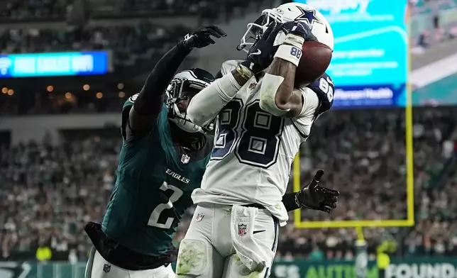 Dallas Cowboys wide receiver Ceedee Lamb (88) makes a catch for a touchdown in front of Philadelphia Eagles cornerback Riq Woolen (2) during the second half of an NFL football game in Philadelphia, Monday, Oct. 26, 2026. (AP Photo/Matt Rourke)