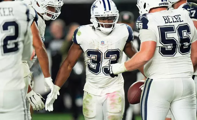 Dallas Cowboys running back Javonte Williams (33) celebrates scoring touchdown during the second half of an NFL football game against the Philadelphia Eagles in Philadelphia, Monday, Oct. 26, 2026. (AP Photo/Chris Szagola)