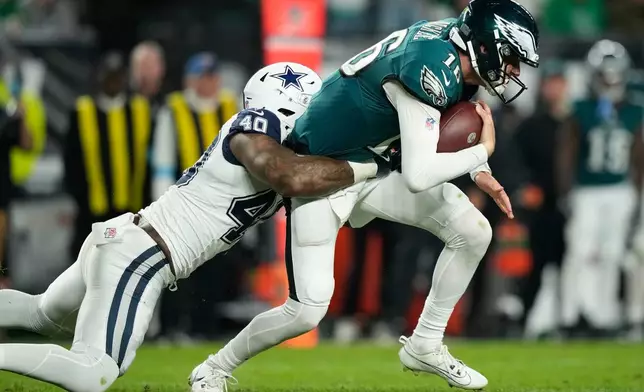 Philadelphia Eagles quarterback Tanner McKee (16) is tackled by Dallas Cowboys outside linebacker Von Miller (40) during the second half of an NFL football game in Philadelphia, Monday, Oct. 26, 2026. (AP Photo/Matt Slocum)