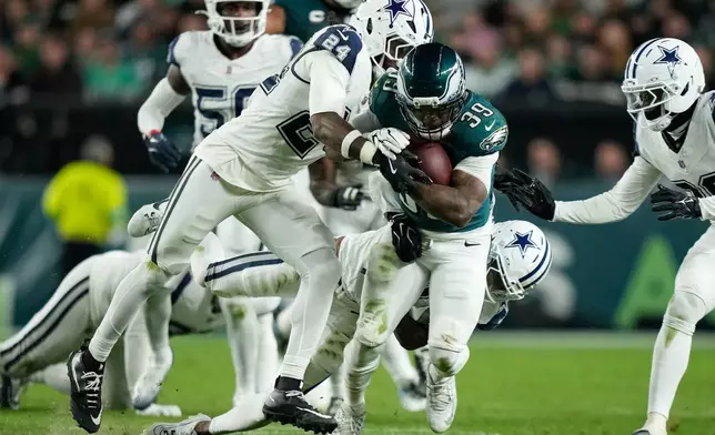 Dallas Cowboys free safety Malik Hooker (24) trie to stop Philadelphia Eagles running back Dameon Pierce (39) during the first half of an NFL football game in Philadelphia, Monday, Oct. 26, 2026. (AP Photo/Matt Slocum)