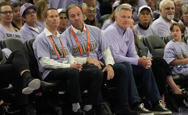 Golden State Valkyries and Warriors owner Joe Lacob, middle, watches with Warriors president and chief operating officer Brandon Schneider, middle left, and Warriors head coach Steve Kerr during the second half of Game 1 of the WNBA basketball finals between the Golden State Valkyries and the Atlanta Dream, Saturday, Oct. 17, 2026, in San Francisco. (AP Photo/Jeff Chiu)