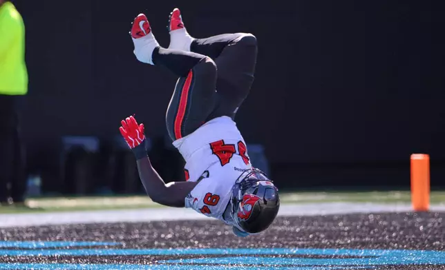Tampa Bay Buccaneers defensive tackle Calijah Kancey (94) returns a fumble for a touchdown during the first half of an NFL football game against the Carolina Panthers in Charlotte, N.C., Sunday, Oct. 25, 2026. (AP Photo/Scott Kinser)
