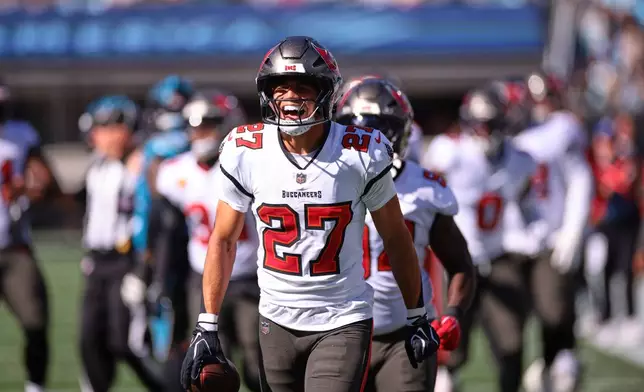 Tampa Bay Buccaneers' Zyon McCollum (27) celebrates an interception with teammates during the first half of an NFL football game against the Carolina Panthers in Charlotte, N.C., Sunday, Oct. 25, 2026. (AP Photo/Scott Kinser)