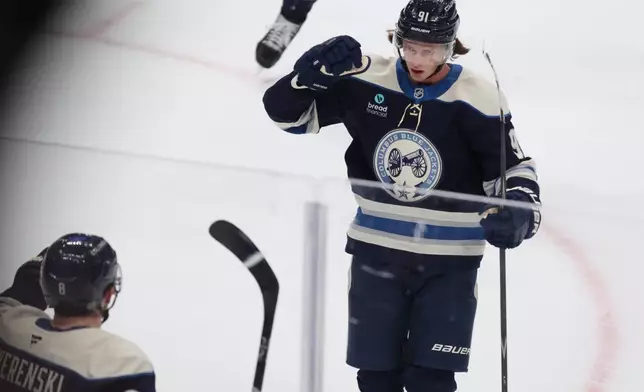 Columbus Blue Jackets forward Kent Johnson, right, celebrates his overtime goal against the New York Rangers with teammate defenseman Zach Werenski during an NHL hockey game in Columbus, Ohio, Saturday, Oct. 17, 2026. (AP Photo/Paul Vernon)