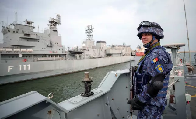 FILE - A Romanian naval serviceman guards onboard the M-270 Mine-hunter during a Romanian Navy led exercise outside Constanta, Romania, Tuesday, April 16, 2024. (AP Photo/Andreea Alexandru, File)