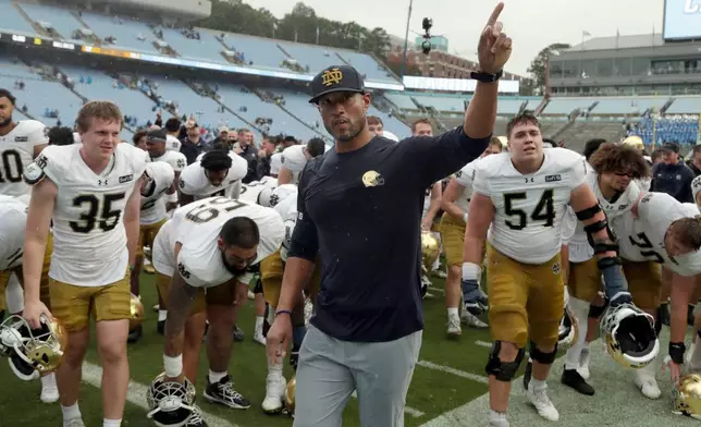 Notre Dame head coach Marcus Freeman and the team recognize their fans at the end of an NCAA college football game against North Carolina, Saturday, Oct. 3, 2026, in Chapel Hill, N.C. (AP Photo/Chris Seward)