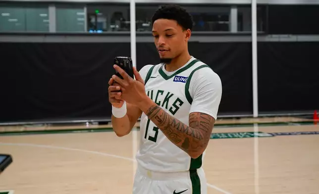 Milwaukee Bucks' Ryan Rollins records a social media video during the NBA basketball team's media day Monday, Sept. 28, 2026, in Milwaukee. (AP Photo/Kayla Wolf)