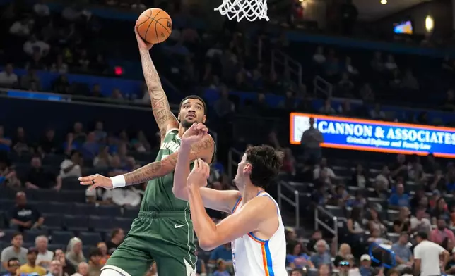 Milwaukee Bucks center Kel'el Ware, left, shoots over Oklahoma City Thunder center Aday Mara during the second half of an NBA basketball game, Wednesday, Oct. 7, 2026, in Oklahoma City. (AP Photo/Kyle Phillips)