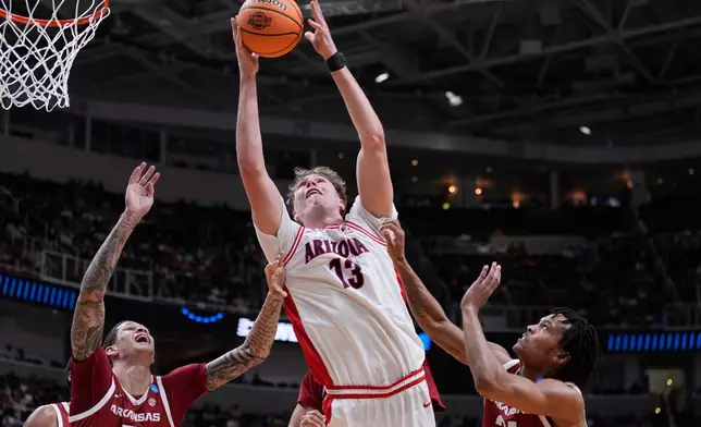 FILE - Arizona center Motiejus Krivas (13) grabs a rebound during the first half in the Sweet 16 of the NCAA college basketball tournament against Arkansas, March 26, 2026, in San Jose, Calif. (AP Photo/Godofredo A. Vásquez, File)
