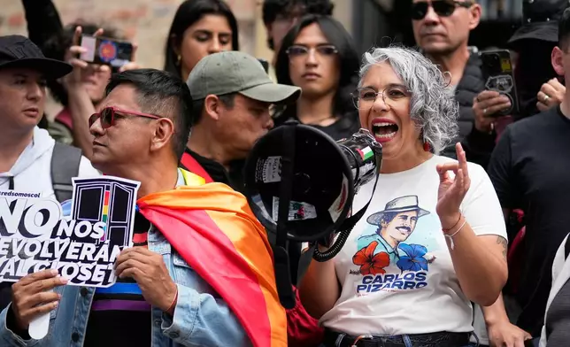 Sen. Maria Jose Pizarro, right, takes part in a protest against President Abelardo de la Espriella's order to remove exhibits about political violence from the National Museum in Bogota, Colombia, Saturday, Oct. 17, 2026. (AP Photo/Fernando Vergara)
