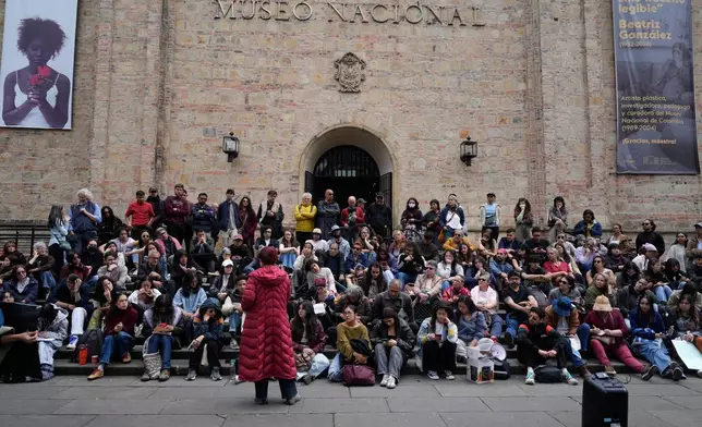 University students hold a class outdoors in front of the National Museum as part of a protest against the removal of some artworks from the museum in Bogota, Colombia, Wednesday, Oct. 21, 2026. (AP Photo/Fernando Vergara)