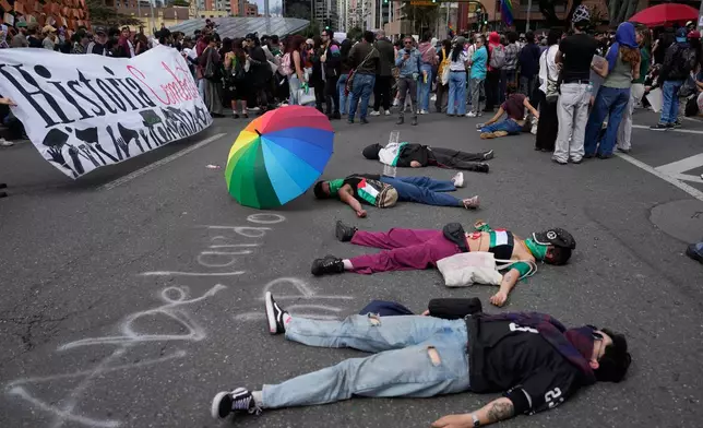 Demonstrators protest against President Abelardo de la Espriella's order to remove exhibits about political violence from the National Museum in Bogota, Colombia, Saturday, Oct. 17, 2026. (AP Photo/Fernando Vergara)
