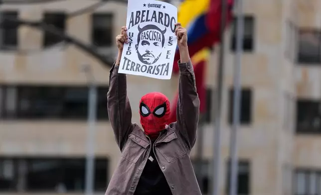 A demonstrator, donning a Spiderman mask, takes part in a protest against President Abelardo de la Espriella's order to remove exhibits about political violence from the National Museum in Bogota, Colombia, Saturday, Oct. 17, 2026. (AP Photo/Fernando Vergara)