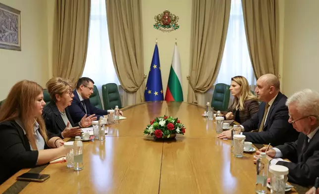 Bulgarian Prime Minister Rumen Radev, 2nd right, speaks with Russian Ambassador to Bulgaria Eleonora Mitrofanova, 2nd left, in Sofia, Bulgaria, Tuesday, Oct. 13, 2026. (Bulgarian Government via AP)