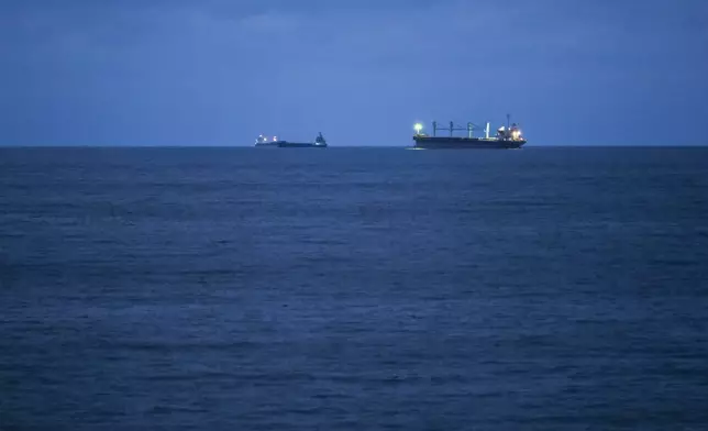 Bulgarian Navy emergency rescue tug Mizar is seen near the ship Azov Concord, where four sailors rescued from the drone-attacked and sunk ship HS Dignity await transportation to the port of Varna, Bulgaria, late Tuesday, Oct. 13, 2026. (Moreto.net via AP)