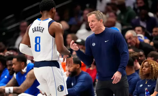 Dallas Mavericks head coach Dusty May talks with guard Marcus Sasser during the first half of an NBA basketball game against the Oklahoma City Thunder Wednesday, Oct. 28, 2026, in Dallas. (AP Photo/Jeffrey McWhorter)
