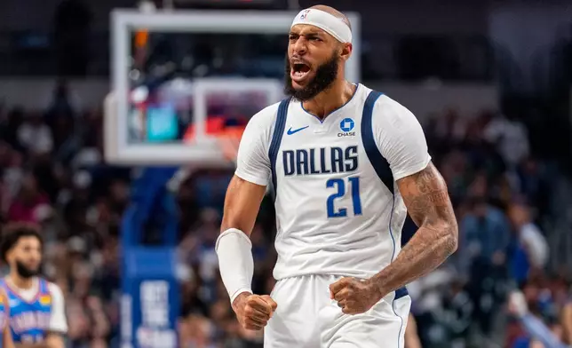 Dallas Mavericks forward Daniel Gafford celebrates after a 3 point basket by guard Max Christie during the first half of an NBA basketball game against the Oklahoma City Thunder Wednesday, Oct. 28, 2026, in Dallas. (AP Photo/Jeffrey McWhorter)