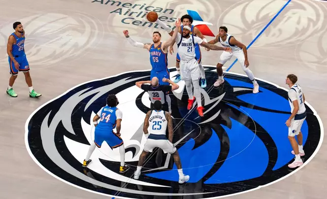 Dallas Mavericks forward Daniel Gafford (21) and Oklahoma City Thunder center Isaiah Hartenstein (55) compete for the opening tip off during the first half of an NBA basketball game Wednesday, Oct. 28, 2026, in Dallas. (AP Photo/Jeffrey McWhorter)