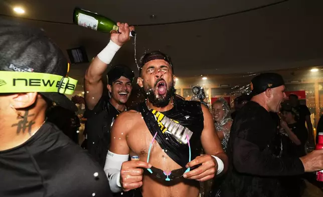 San Diego Padres right fielder Fernando Tatis Jr. celebrates with teammates after defeating the Chicago Cubs in Game 2 of the National League Wild Card baseball playoff series Wednesday, Sept. 30, 2026, in San Diego. (AP Photo/Gregory Bull)