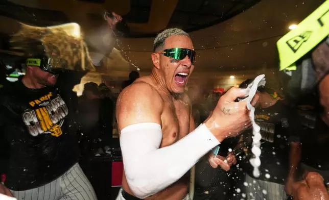 San Diego Padres third baseman Manny Machado celebrates with teammates after defeating the Chicago Cubs in Game 2 of the National League Wild Card baseball playoff series Wednesday, Sept. 30, 2026, in San Diego. (AP Photo/Gregory Bull)