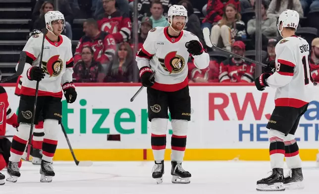 Ottawa Senators' Stephen Halliday, center, celebrates his goal with teammates during the second period of an NHL hockey game against the New Jersey Devils in Newark, N.J., Monday, Oct. 12, 2026. (AP Photo/Seth Wenig)