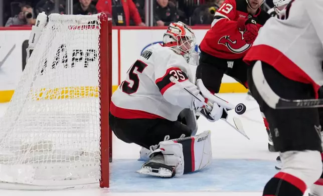 Ottawa Senators goaltender Linus Ullmark makes a save during the second period of an NHL hockey game against the New Jersey Devils in Newark, N.J., Monday, Oct. 12, 2026. (AP Photo/Seth Wenig)