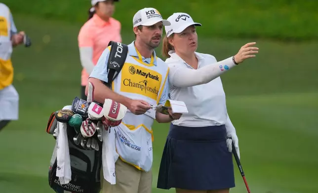 Perrine Delacour of France, right, speaks with her caddie on the second hole during the first round of the LPGA Maybank Championship golf tournament in Kuala Lumpur, Malaysia, Thursday, Oct. 29, 2026. (AP Photo/Vincent Thian)
