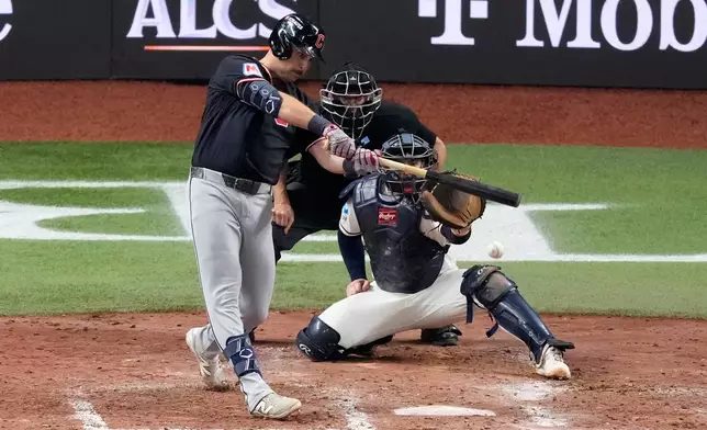 Cleveland Guardians' Nathaniel Lowe hits an RBI-single against the Tampa Bay Rays during the sixth inning in Game 6 of an American League Championship Series baseball game in St. Petersburg, Fla. Monday, Oct. 19, 2026. (AP Photo/Chris O'Meara)