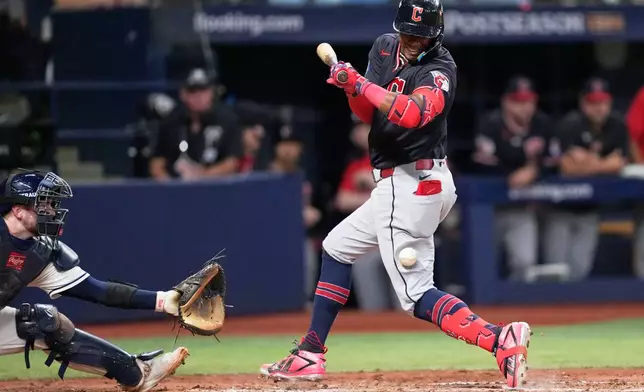 Cleveland Guardians' Angel Martínez gets hit by a pitch with the bases loaded against the Tampa Bay Rays during the eighth inning in Game 6 of an American League Championship Series baseball game in St. Petersburg, Fla. Monday, Oct. 19, 2026. (AP Photo/David J. Phillip)