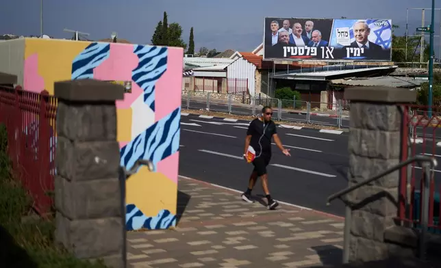 An election campaign billboard featuring Israeli Prime Minister Benjamin Netanyahu, leader of the Likud party, and other politicians hangs in Kiryat Shmona, Israel's largest northern city, near Lebanon's border, ahead of the country's general election, Tuesday, Oct. 13, 2026. The Hebrew writing reads, "Right or Palestine." (AP Photo/Ariel Schalit)