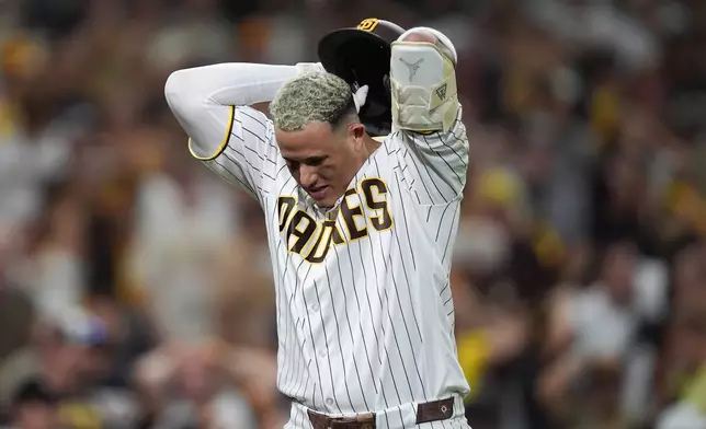 San Diego Padres' Manny Machado reacts after he flied out during the eighth inning in Game 4 of baseball's National League Division Series against the Milwaukee Brewers Wednesday, Oct. 7, 2026, in San Diego. (AP Photo/Gregory Bull)