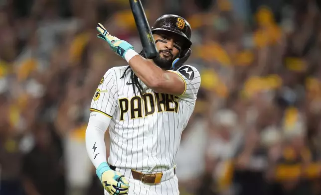 San Diego Padres' Fernando Tatis Jr. flips his bat after hitting a home run against the Milwaukee Brewers during the third inning in Game 4 of baseball's National League Division Series Wednesday, Oct. 7, 2026, in San Diego. (AP Photo/Gregory Bull)