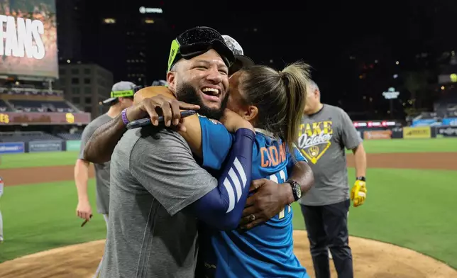 Milwaukee Brewers' Jackson Chourio celebrates with family members after the team defeated the San Diego Padres in Game 4 of baseball's National League Division Series Wednesday, Oct. 7, 2026, in San Diego. (AP Photo/Derrick Tuskan)