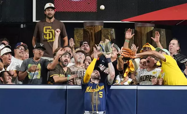 Milwaukee Brewers center fielder Garrett Mitchell catches a ball hit by San Diego Padres' Manny Machado during the eighth inning in Game 4 of baseball's National League Division Series Wednesday, Oct. 7, 2026, in San Diego. (AP Photo/Gregory Bull)