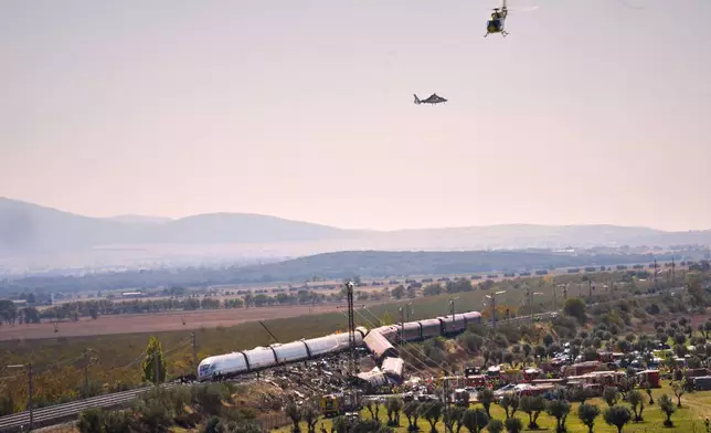 Emergency services work at the scene of a collision between two trains in Urda, Spain, on Wednesday, Oct. 28, 2026. (AP Photo/Manu Fernandez)