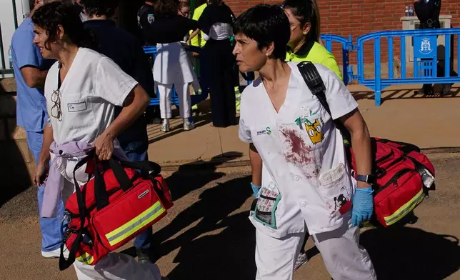Medical staff arrive at a sports center converted into a temporary medical facility following a collision between two trains in Urda, Spain, Wednesday, Oct. 28, 2026. (AP Photo/Andrea Comas)