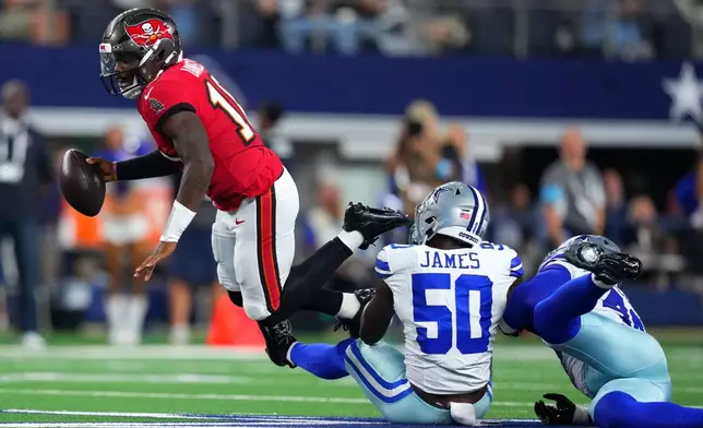 Tampa Bay Buccaneers quarterback Jalon Daniels (10) is sacked by Dallas Cowboys linebackers Shemar James (50) and Von Miller (40) in the first half of an NFL football game in Arlington, Texas on Thursday, Oct. 8, 2026. (AP Photo/Julio Cortez)