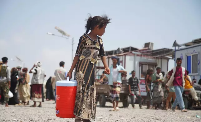 A displaced Yemeni girl walks at Al-Firdaws 2 camp in Ras Imran, on the western outskirts of Aden, Yemen, Yemen, Tuesday, Oct. 20, 2026. (AP Photo/Abdulnasser Alseddik)