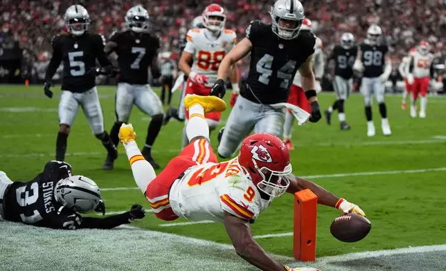 Kansas City Chiefs running back Kenneth Walker (9) dives to score a touchdown past Las Vegas Raiders safety Treydan Stukes (31) during the second half of an NFL football game in Las Vegas, Sunday, Oct. 4, 2026. (AP Photo/John Locher)
