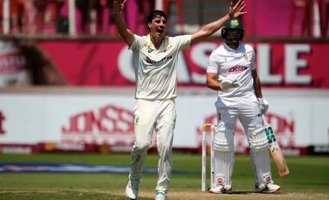Australia's captain Pat Cummins, left, appeals unsuccessful for LBW against South Africa's Wiaan Mulder on day three of the first cricket test match between South Africa and Australia, in Durban, South Africa, Sunday, Oct. 11, 2026. (AP Photo/Themba Hadebe)
